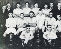 The Balaclava soccer team around 1938 with their championship trophy.<br><br>First formed in 1937, the team became part of the Sydenham Soccer League, which included three other communities. The following year, the team went on to win the championship. Soccer Team