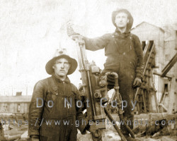A group of miners with a drill, ca. 1910 Miners