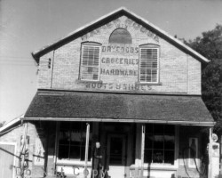Napier House; around 1960. Apart from the fence at the side, the replacement of the horse with gas pumps and the curious disappearance of the 'electric beans', it's amazing how few changes took place over the course of 50 years. Store