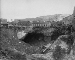 The shaft precariously sitting by the hole following the cave-in that occurred in Oct. 1927. The train station can be seen off to the left. Photo of the cave-in